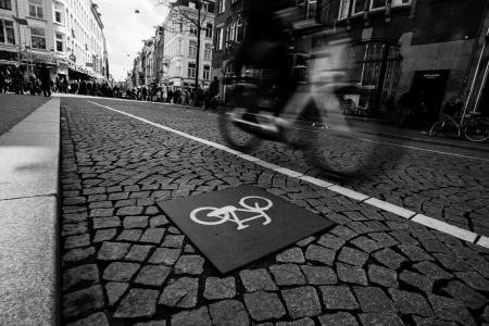 silhouette of cyclist on the street passing bike route sign. Black and white. Netherlands, Amsterdamのeditorial素材