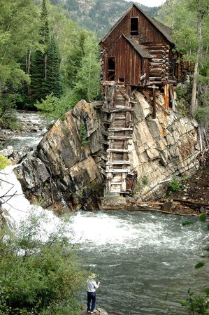 man fishing pool below the crystal mill, an iconic 19th century example of colorado mining architecture の写真素材
