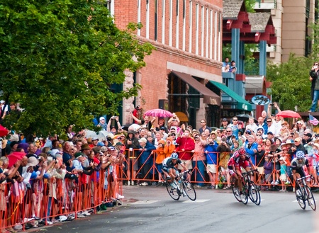 Aspen, CO - Aug. 24, 2011: A packed crowd cheers George Hincapie of BMC racing team on his final sprint to the finish winning the Queen Stage of USA Pro Cycling Challange in historic downtown Aspen, Co. on Aug 24, 2011のeditorial素材