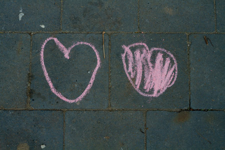 childish painting made by colored chalk on a pavement - heartsの写真素材