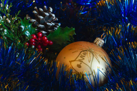 gold chrstmas ball, deep blue christmas tree chain and coneの写真素材