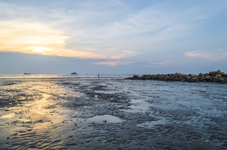 Tropical colorful sunset at the stones beach