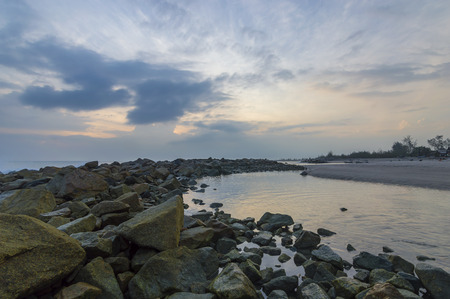 Stone beach with sunrise background