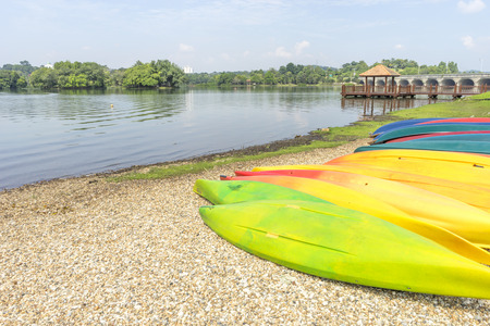 a group of coloring canoe near the lakeのeditorial素材