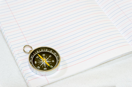 Compass on white bookの写真素材