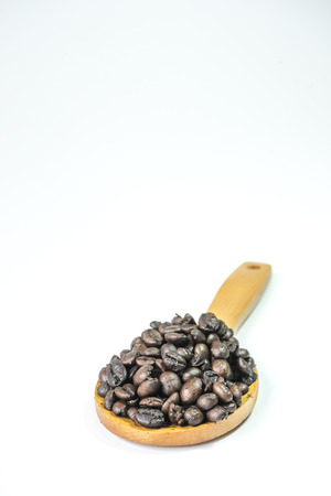 Coffee beans on a wooden ladleの写真素材