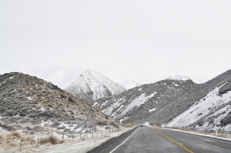 Empty mountain road on a cloudy winter day. South Island, New Zealandの写真素材