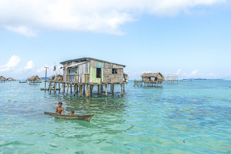 SABAH, MALAYSIA - AUGUST 15, 2016 : Unidentified Bajau Laut kids on a boat in Bodgaya Island, Sabah, Malaysia. They lived in a house built on stilts in the middle of sea, boat is the main transportation here.のeditorial素材
