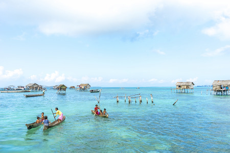 SABAH, MALAYSIA - AUGUST 15, 2016 : Unidentified Bajau Laut kids on a boat in Bodgaya Island, Sabah, Malaysia. They lived in a house built on stilts in the middle of sea, boat is the main transportation here.のeditorial素材
