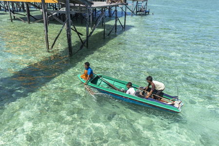 SABAH, MALAYSIA - AUGUST 16, 2016 : Tree local villager searching for buyer for their daily income at Mabul Island, Sabah, Malaysia.のeditorial素材