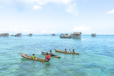 SABAH, MALAYSIA - AUGUST 15, 2015: Unidentified Bajau Laut kids on a boat in Bodgaya Island, Sabah, Malaysia. They lived in a house built on stilts in the middle of sea, boat is the main transportation hereのeditorial素材