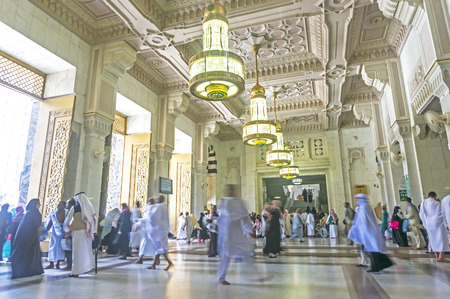 MECCA, SAUDI ARABIA - MAR 14: Muslim pilgrims walk in and out inside Masjidil Haram on March 14, 2015 in Mecca, Saudi Arabia.のeditorial素材