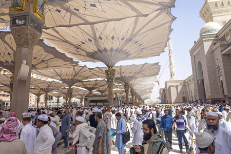 MEDINA - MARCH 06 : Pilgrims walk out after praying at Nabawi Mosque compound on March 06, 2015 in Medina, Kingdom of Saudi Arabia. Nabawi mosque is the second holiest mosque in Islam.のeditorial素材
