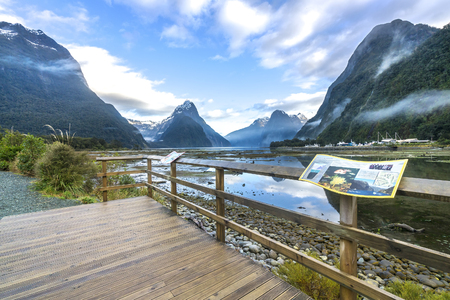 MILFORD SOUND, NEW ZEALAND - SEP 04, 2016 : View of mountain with reflection from wooden platform.のeditorial素材