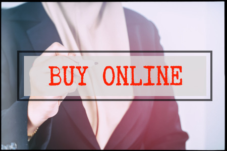 Hand and text BUY ONLINE with vintage backgound. Technology concept.の写真素材