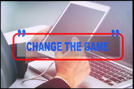 Hand and text  "CHANGE THE GAME" with vintage background. Technology concept.の写真素材