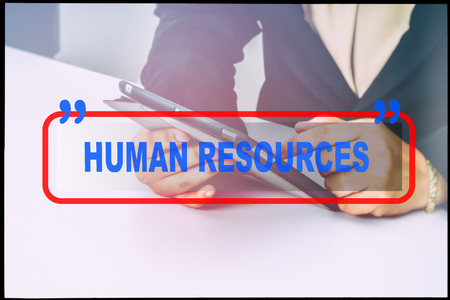 Hand and text  "HUMAN RESOURCES" with vintage background. Technology concept.の写真素材
