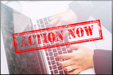 Hand with red grunge stamp with text "ACTION NOW". Technology concept.の写真素材