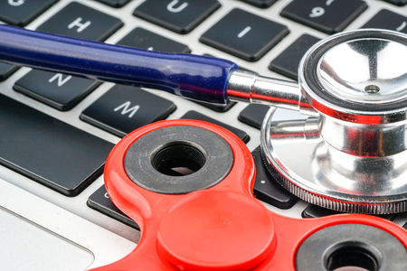 Fidget spinner and stethoscope with close up view.の写真素材