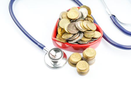 Coins and stethoscope with white backgroundの写真素材