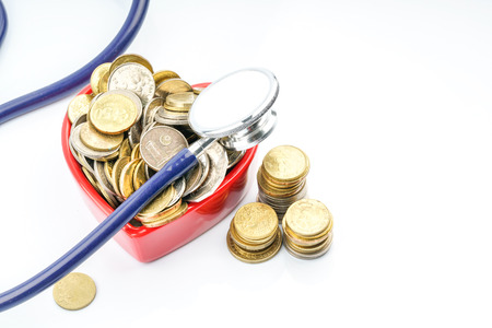 Coins and stethoscope with with background.の写真素材