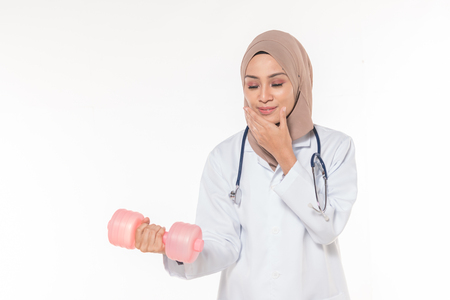 Hijab medical doctor with dumbbell. Healthy concept.の写真素材