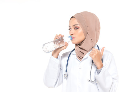 Hijab medical doctor hold mineral water. Healthy concept.の写真素材