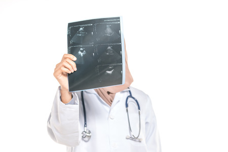 Hijab medical doctor looking at x-ray pictureの写真素材