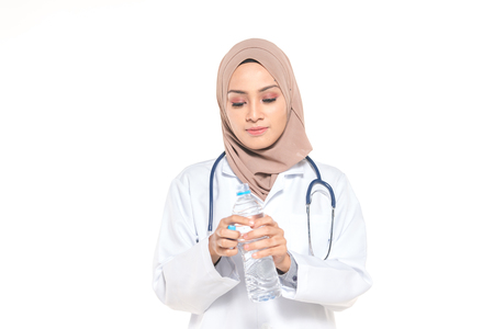 Hijab medical doctor hold mineral water. Healthy concept.の写真素材