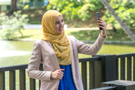 veiled teenager with muslimah lifestyle concept at green garden.の写真素材