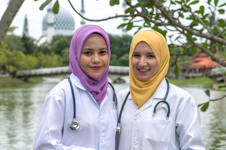 Veiled teenager with muslimah medical concept at green garden.の写真素材