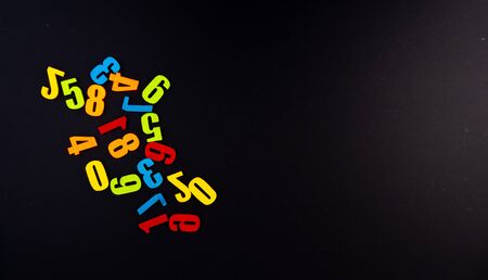 Colorful numbers on black background with educational concept.