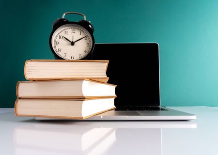 Laptop and book with educational concept.の写真素材