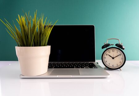 Laptop and clock with punctuality concept.の写真素材