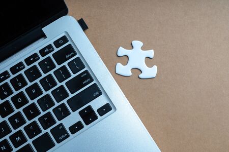Laptop and jigsaw from above viewの写真素材