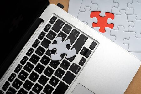 Laptop and jigsaw from above viewの写真素材