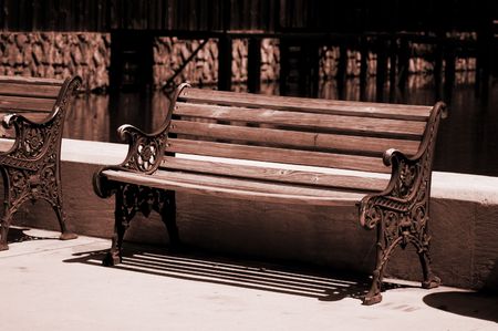 park bench next to waterの写真素材