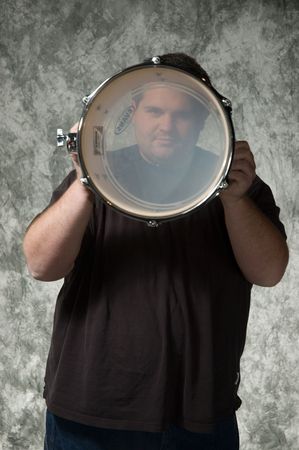 overweight young man posing in front of portrait backdropの写真素材