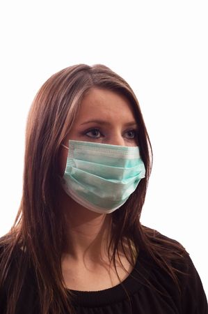 Girl infected with influenza A and mask isolated over whiteの写真素材