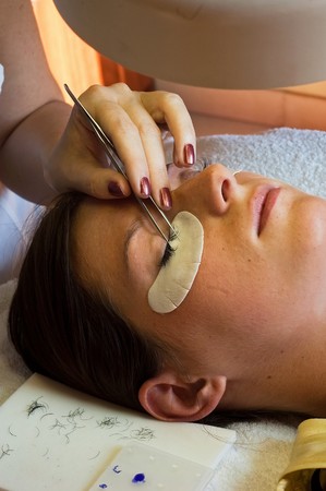 prolonging and supplementing eyelashes in a beauty salonの写真素材
