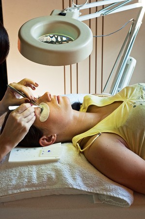 prolonging and supplementing eyelashes in a beauty salonの写真素材