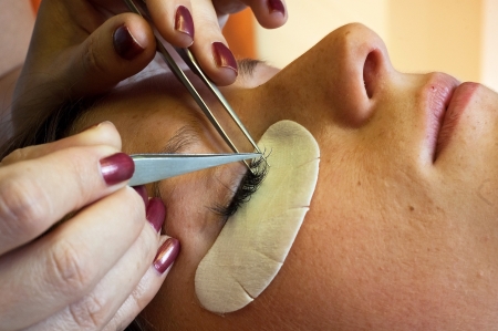 prolonging and supplementing eyelashes in a beauty salonの写真素材