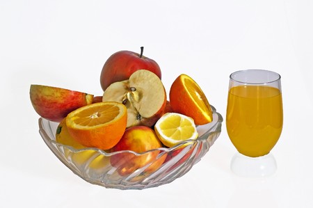Fruit mix and the orange juice on the white backgroundの写真素材