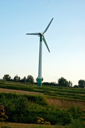 Windmill turning on the sunsetの写真素材