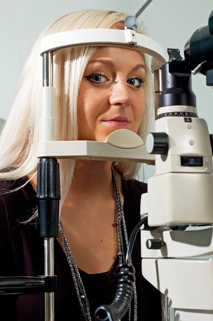 Young woman examining the eyesight in the optician'sの写真素材