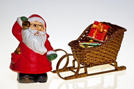 Santa Claus pulls the sledge overfilled with the Christmas giftsの写真素材