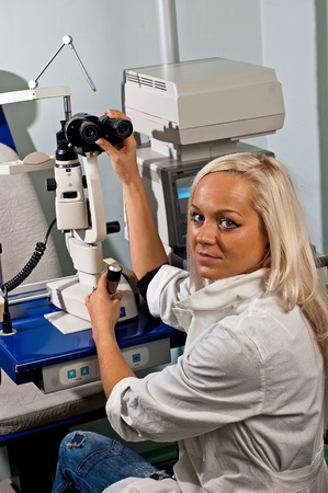 Young woman examining the eyesight in the optician'sの写真素材