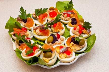 stuffed eggs with pastes with caviar, fish and olives の写真素材