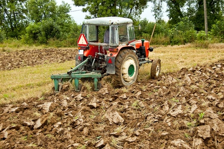 ploughing field on old tractor in southern Polandの写真素材