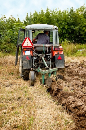 ploughing field on old tractor in southern Polandの写真素材